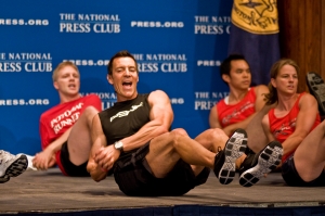 Fitness trainer Tony Horton, middle in black shirt and shorts, leads the luncheon audience in a workout, which incorporated elements of his P90X fitness system.